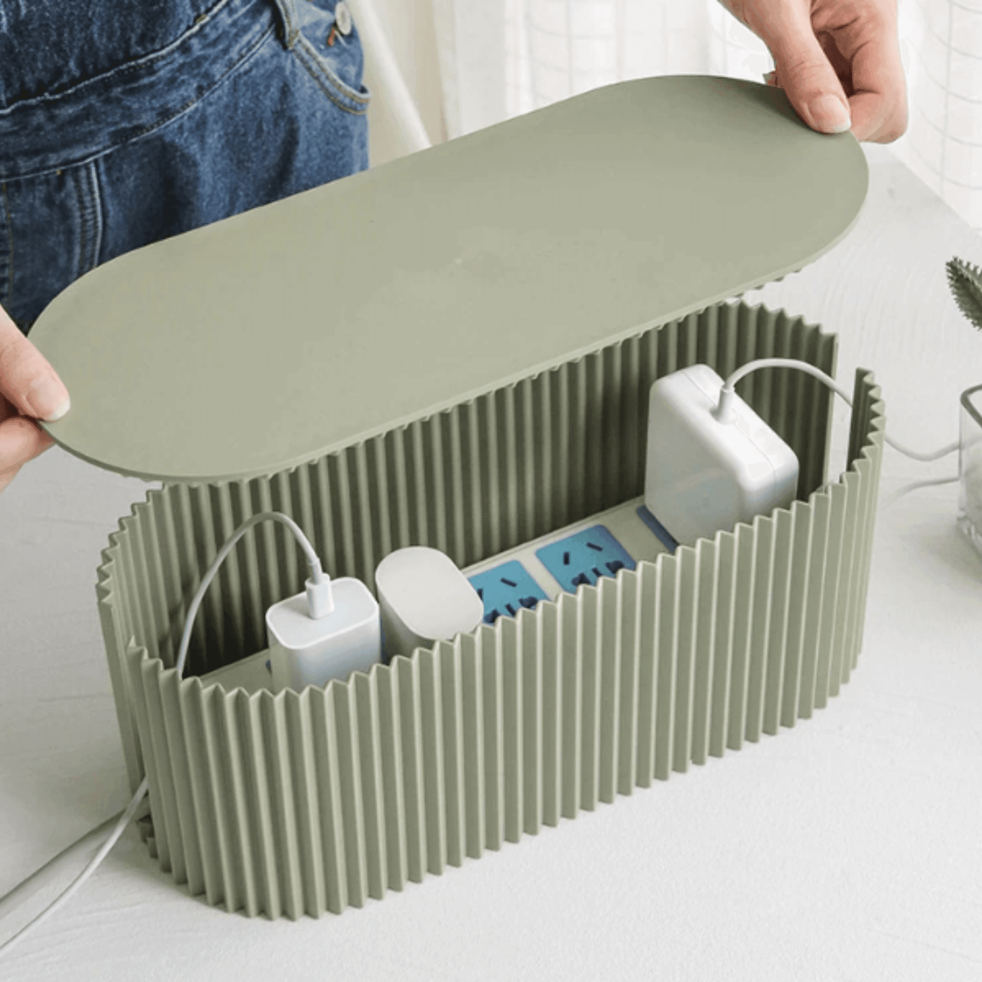 Open ribbed cable organizer box showing interior space for cables and power strip