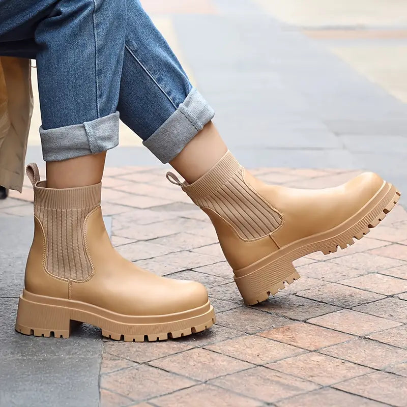 Beige chunky Chelsea boots with ribbed elastic side panels and a thick lug sole
