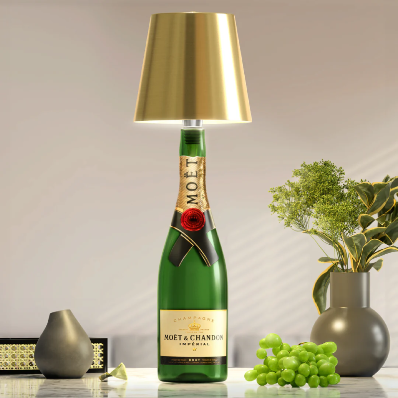 Bottle-shaped table lamp with a Moët & Chandon style champagne bottle base and a gold lampshade.