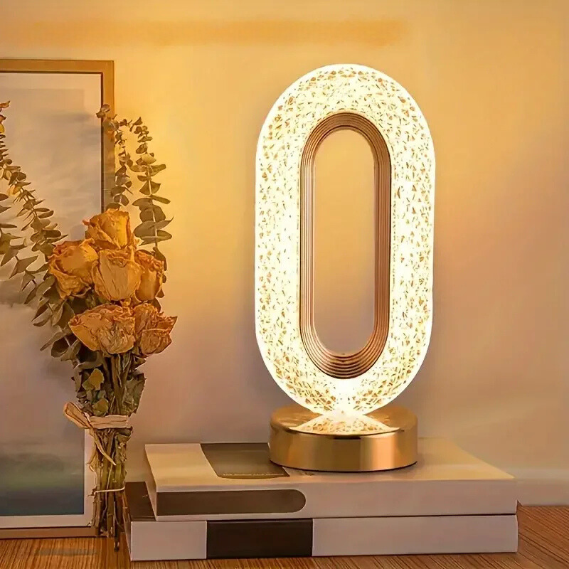 Oval LED table lamp with crystal-textured shade and gold base, warm white light