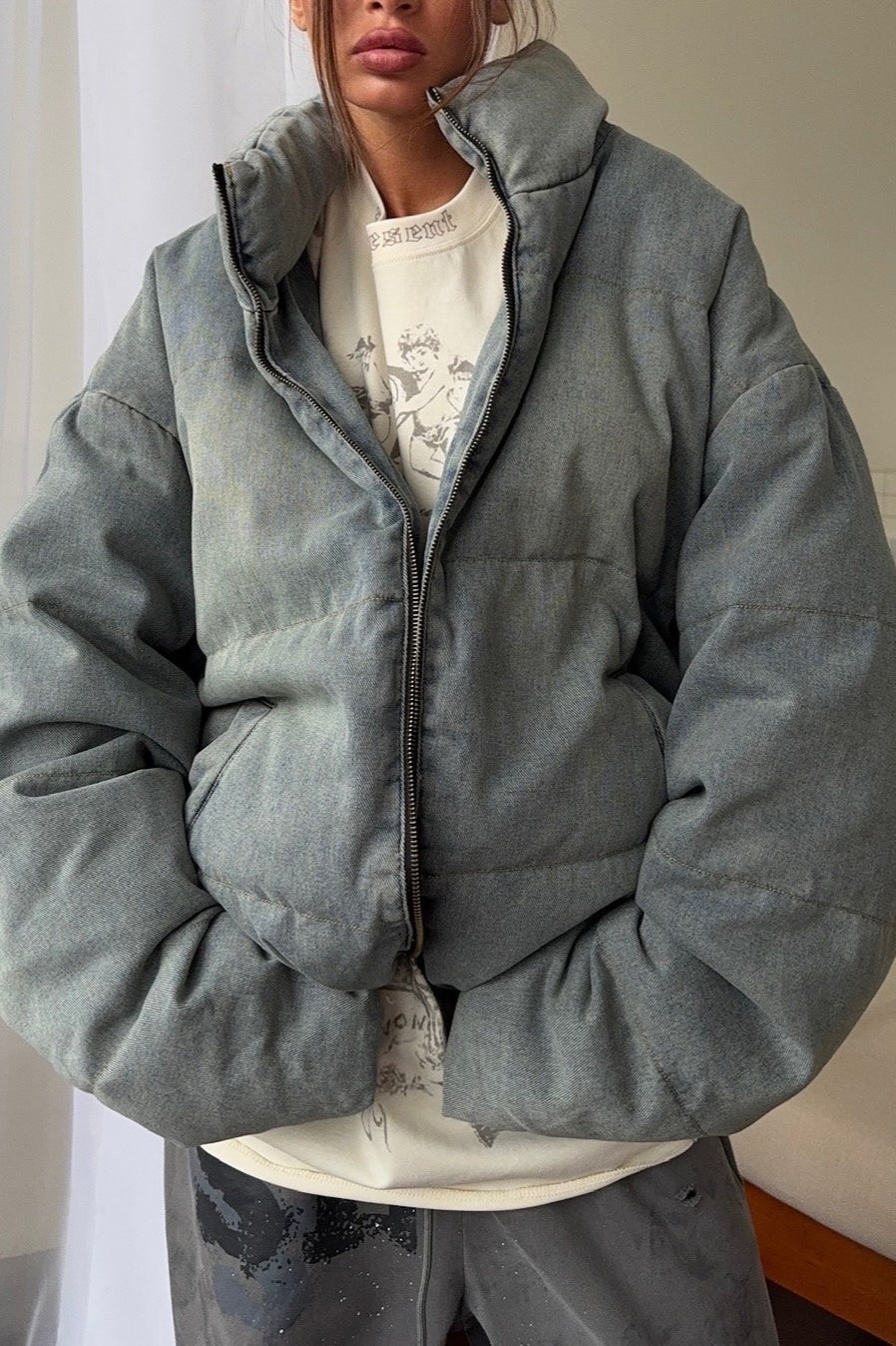 Padded jacket with zip front and high collar, oversized fit, women, worn indoors