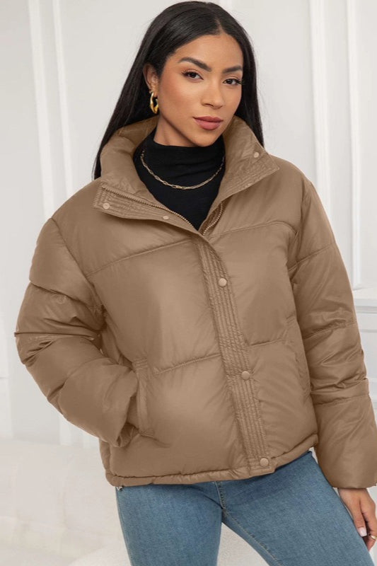 Padded puffer jacket with snap button front and high collar, loose fit, women, worn indoors