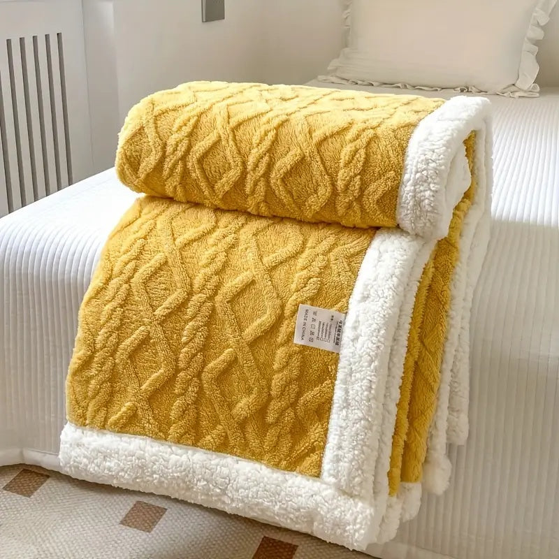 Mustard yellow plush sherpa blanket with textured pattern and white sherpa edge.