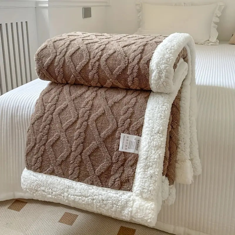 Brown plush sherpa blanket with textured cable pattern and white sherpa trim.