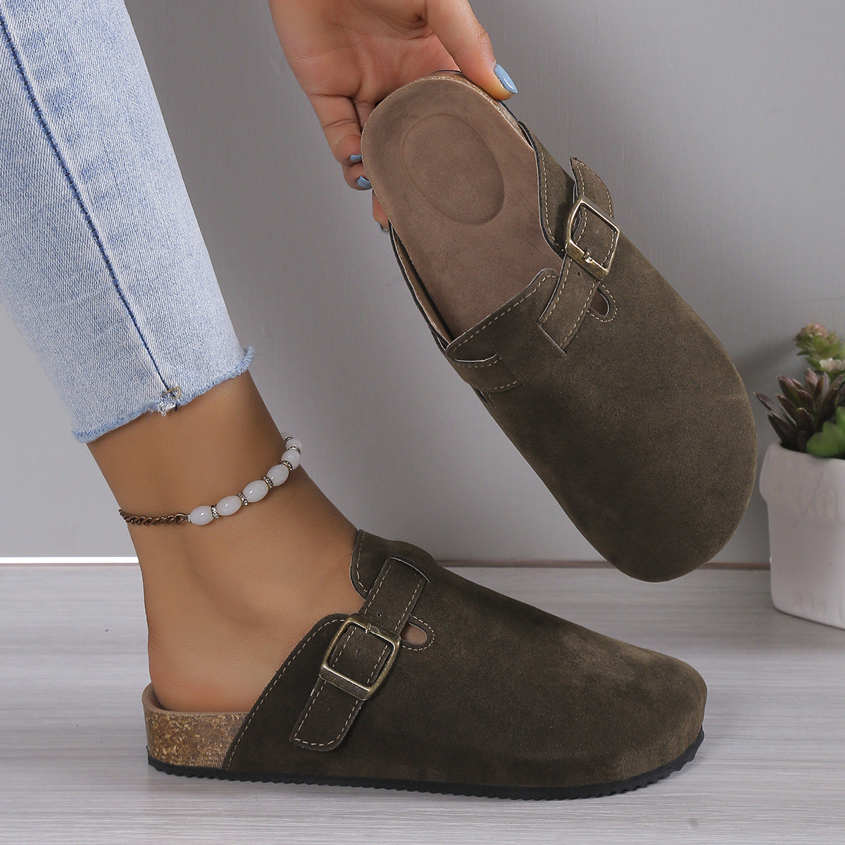 Slip-on clog with closed rounded toe and cut-out detailing on the upper