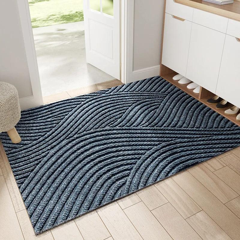 Blue textured entryway rug with diagonal geometric pattern in a hallway.