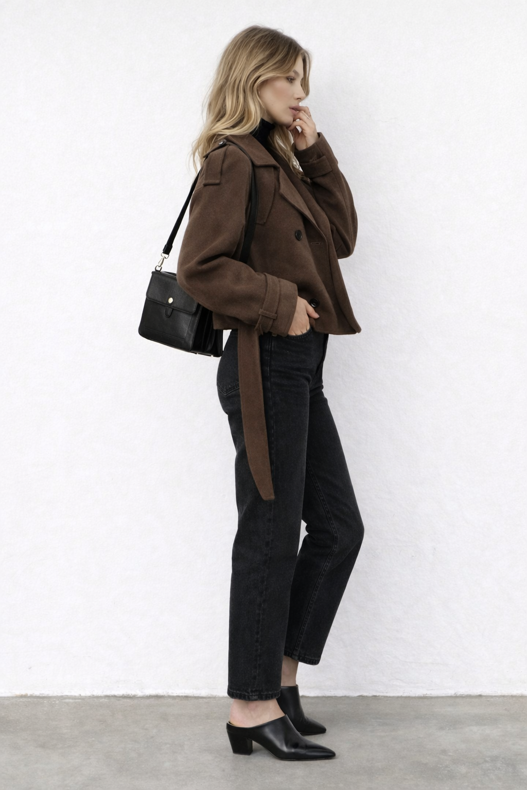 Structured woven coat with belt detail styled over layered knitwear for women
